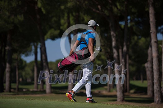 handsome middle eastern golf player carrying bag and walking at course to next hole handsome middle eastern golf player carrying bag and walking at course to next hole