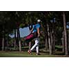 handsome middle eastern golf player carrying  bag  and walking at course to next hole