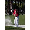 golf player shot ball from sand bunker at course