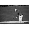 golf player shot ball from sand bunker at course