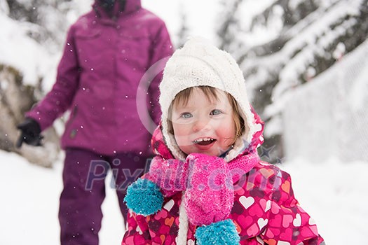 portrait of happy smiling little girl child outdoors having fun and playing on snowy winter day portrait of happy smiling little girl child outdoors having fun and playing on snowy winter day