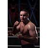 professional kickboxer with hands in martial arts position training for the fight in the training ring