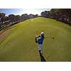 top view of golf player hitting shot with club on course at beautiful morning