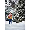 Young woman ice skating outdoors on a pond on a freezing winter day (color toned image; motion blurred image)