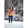 Young woman ice skating outdoors on a pond on a freezing winter day (color toned image; motion blurred image)