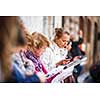 Gorgeous female tourist with a map discovering a foreign city (shallow DOF; color toned image)