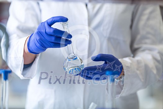 Senior male researcher carrying out scientific research in a lab (shallow DOF; color toned image) Senior male researcher carrying out scientific research in a lab (shallow DOF; color toned image)