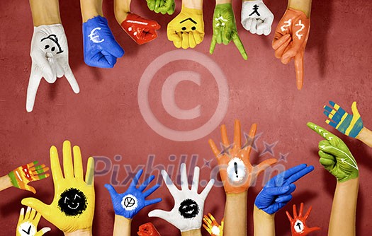 Human hands in colorful paint showing symbols Human hands in colorful paint showing symbols