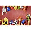 Human hands in colorful paint showing symbols