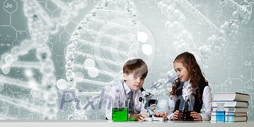 Two cute children at chemistry lesson making experiments Two cute children at chemistry lesson making experiments