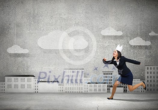 Young businesswoman in paper crown running in a hurry