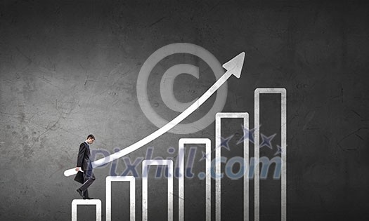 Young businessman walking up on growing graph representing success concept Young businessman walking up on growing graph representing success concept