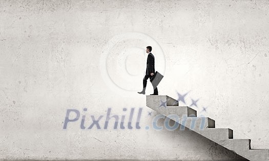 Young businessman walking up on staircase representing success concept Young businessman walking up on staircase representing success concept