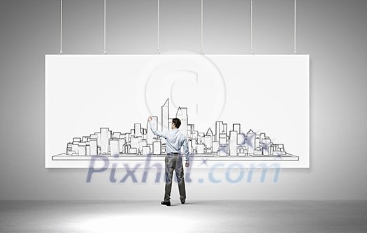 Rear view of builder man drawing construction project on white banner Rear view of builder man drawing construction project on white banner