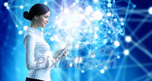 Businesswoman with tablet pc against high tech blue background Businesswoman with tablet pc against high tech blue background