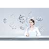 Attractive businesswoman sitting at table and using tablet