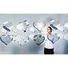 Attractive businesswoman touching high tech heart icon