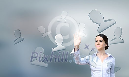 Businesswoman pressing modern social icons on virtual screen Businesswoman pressing modern social icons on virtual screen
