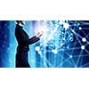 Businesswoman with mobile phone against high tech background