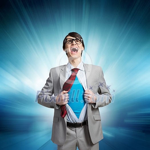 Young businessman acting like super hero and tearing his shirt off Young businessman acting like super hero and tearing his shirt off