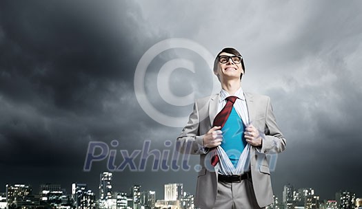 Young smiling businessman acting like super hero and tearing his shirt off Young smiling businessman acting like super hero and tearing his shirt off