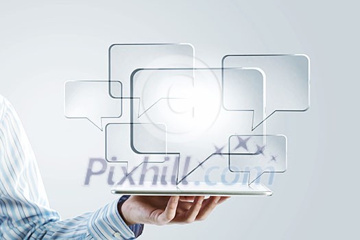Close up of businessman hand holding tablet and glass symbols Close up of businessman hand holding tablet and glass symbols