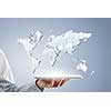 Businessman hands holding tablet with world map on screen