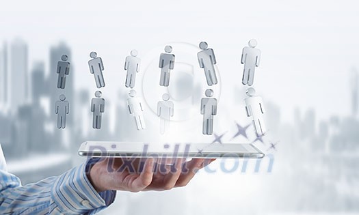 Close up of businessman hand holding tablet and glass symbols Close up of businessman hand holding tablet and glass symbols