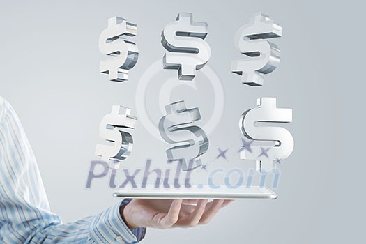 Close up of businessman hand holding tablet and glass dollar symbols Close up of businessman hand holding tablet and glass dollar symbols