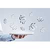 Close up of businessman hand holding tablet and glass symbols