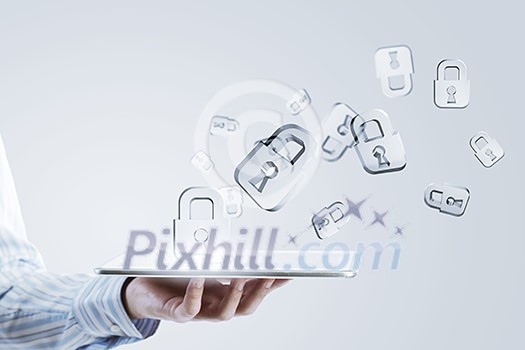 Close up of businessman hand holding tablet and glass symbols Close up of businessman hand holding tablet and glass symbols