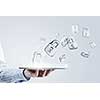 Close up of businessman hand holding tablet and glass symbols