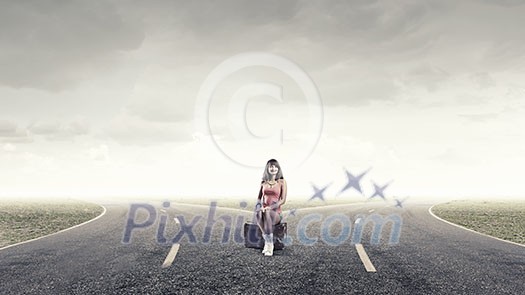 Traveler woman sits on retro suitcase and waiting for car