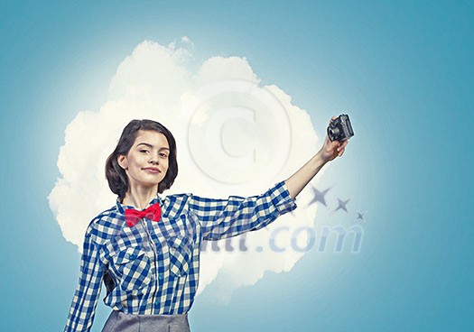 Young beautiful woman making selfie photo with retro camera Young beautiful woman making selfie photo with retro camera