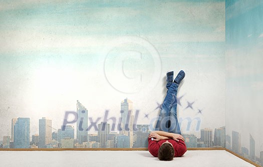 Young man lying on floor with legs raised up Young man lying on floor with legs raised up
