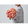 A very beautiful bouquet of pink roses is held by a woman. the best gift for a girl in Valentine's Day.