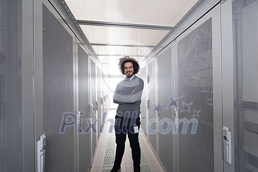 portrait of young handsome IT engeneer in datacenter server room
