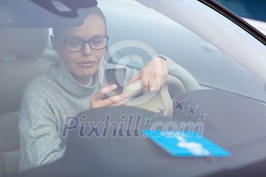 Pretty, young woman driving her new car - putting the necessary parking clock behind the windshield(color toned image; shallow DOF) Pretty, young woman driving her new car - putting the necessary parking clock behind the windshield(color toned image; shallow DOF)