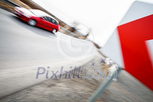 Traffic concept: car driving fast through a sharp turn (motion blur is used to convey movement) Traffic concept: car driving fast through a sharp turn (motion blur is used to convey movement)
