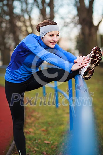 Young woman stretching before her run Young woman stretching before her run
