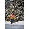 Young woman ice skating outdoors on a pond on a freezing winter day (color toned image; motion blurred image)