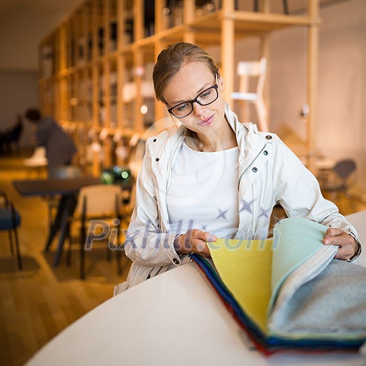 Pretty young woman choosing the right material/color for her modern appartement interior (shallow DOF; color toned image) Pretty young woman choosing the right material/color for her modern appartement interior (shallow DOF; color toned image)