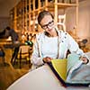 Pretty young woman  choosing the right material/color for her modern appartement interior (shallow DOF; color toned image)