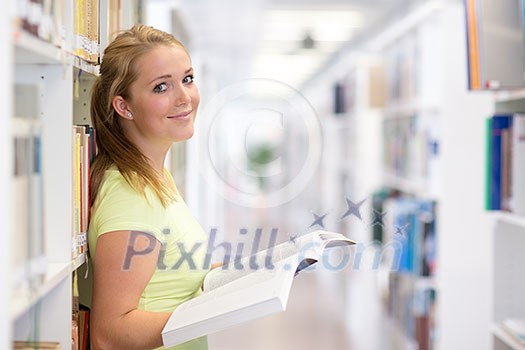Pretty, female student in a library Pretty, female student in a library
