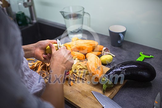 Young woman cooking in her modern kitchen (shallow DOF; color toned image) Young woman cooking in her modern kitchen (shallow DOF; color toned image)