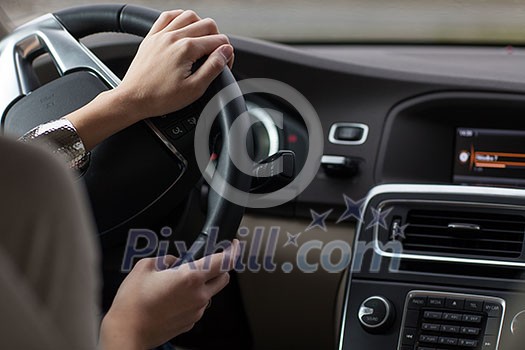 Young woman driving a modern car Young woman driving a modern car