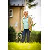 Senior woman doing some gardening in her lovely garden - watering the plants