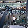 Young female passenger at the airport, transfering to her gate to board her flight on time(color toned image)