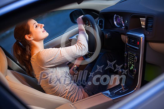 Pretty young woman driving her new car Pretty young woman driving her new car