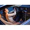 Pretty young woman driving her new car